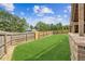 Spacious backyard with a wooden fence offering privacy and a lush green lawn for outdoor activities at 2755 Evan Manor Ln, Cumming, GA 30041