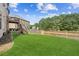 Spacious backyard with lush green grass, a wooden fence, and a two story deck at 2755 Evan Manor Ln, Cumming, GA 30041