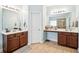 Spacious bathroom featuring double vanities with dark wood cabinets and a separate makeup vanity area at 2755 Evan Manor Ln, Cumming, GA 30041
