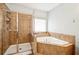 Bathroom with a tiled shower and separate tiled soaking tub at 2755 Evan Manor Ln, Cumming, GA 30041