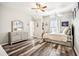 Charming bedroom with hardwood floors, a dresser, and a cozy window seat at 2755 Evan Manor Ln, Cumming, GA 30041