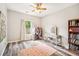 Inviting bedroom with wood-look floors, a vanity, and a large window offering natural light at 2755 Evan Manor Ln, Cumming, GA 30041