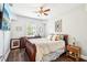 Cozy bedroom with wood floors, ceiling fan, and a window for natural light at 2755 Evan Manor Ln, Cumming, GA 30041