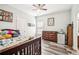 Comfortable bedroom with a wooden bed frame, dresser, and mini fridge at 2755 Evan Manor Ln, Cumming, GA 30041