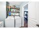 Laundry room with shelving and side-by-side washer and dryer, adjacent to gym at 2755 Evan Manor Ln, Cumming, GA 30041