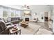 Spacious living room featuring a fireplace, gray vinyl floors, and large windows for natural light at 2755 Evan Manor Ln, Cumming, GA 30041