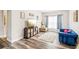 Cozy living room with a plush blue sofa, wood-look floors, and a playful area rug at 2755 Evan Manor Ln, Cumming, GA 30041