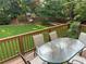 Outdoor dining space with lush green grass, play structure, and brown privacy fence at 3641 Bramblewood Way, Marietta, GA 30062