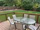 Spacious wooden deck featuring a glass-top table with chairs, perfect for outdoor dining at 3641 Bramblewood Way, Marietta, GA 30062