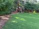 Expansive backyard with lush greenery featuring a playhouse and swing set at 3641 Bramblewood Way, Marietta, GA 30062