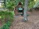 Wooded backyard with playhouse featuring a slide, climbing wall, and swing set at 3641 Bramblewood Way, Marietta, GA 30062