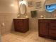 Double vanity bathroom with tan tile and granite countertops provide classic appeal at 3641 Bramblewood Way, Marietta, GA 30062