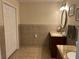 Updated bathroom features double vanity, granite countertops and tan tile throughout the room at 3641 Bramblewood Way, Marietta, GA 30062