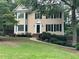 Charming two-story home with manicured lawn and classic design details like black shutters and bay windows at 3641 Bramblewood Way, Marietta, GA 30062