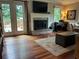 Living room featuring brick fireplace, large windows offering natural light, and hardwood floors at 3641 Bramblewood Way, Marietta, GA 30062