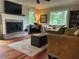 Bright living room boasts a brick fireplace, large windows, hardwood floors, and comfortable seating arrangements at 3641 Bramblewood Way, Marietta, GA 30062