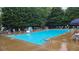 Outdoor pool surrounded by lounge chairs, umbrellas, and lush greenery at 3641 Bramblewood Way, Marietta, GA 30062