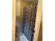Tiled shower featuring a patterned curtain and a white bath mat for comfort and style at 3641 Bramblewood Way, Marietta, GA 30062