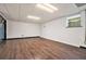 The spacious basement has a hardwood floor, window, and a door, ready to be customized at 4141 Willow Ridge Rd, Douglasville, GA 30135