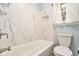 The bathroom features a shower-tub combo with marble tile, providing a luxurious bathing experience at 4141 Willow Ridge Rd, Douglasville, GA 30135
