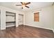 Bedroom featuring hardwood floors, ceiling fan, and closet with built-in shelving and easy access at 4141 Willow Ridge Rd, Douglasville, GA 30135