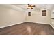 This bright bedroom features hardwood floors, a ceiling fan, and two windows with natural light at 4141 Willow Ridge Rd, Douglasville, GA 30135