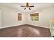 Bright bedroom with hardwood floors and two windows with wooded views, and a closet in the corner at 4141 Willow Ridge Rd, Douglasville, GA 30135
