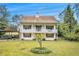 Charming two-story home featuring a welcoming porch on both levels and a spacious front yard with a young tree at 4141 Willow Ridge Rd, Douglasville, GA 30135