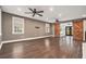 Spacious living room with hardwood floors, recessed lighting, fan, and sliding barn doors leading to sunroom at 4141 Willow Ridge Rd, Douglasville, GA 30135