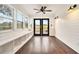 Bright sunroom with hardwood floors, white walls, recessed lights, a ceiling fan, built-in bench, and a door to back deck at 4141 Willow Ridge Rd, Douglasville, GA 30135