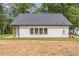 Rear exterior view of home with light siding, a dark gray roof, and an expansive grassy yard at 623 Hamilton E Holmes Nw Dr, Atlanta, GA 30318