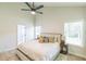 Well-lit main bedroom featuring a plush bed, side tables, and ample natural light at 623 Hamilton E Holmes Nw Dr, Atlanta, GA 30318
