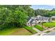 Beautiful home with a mix of dark gray, light, and white colors; surrounded by green trees and grass at 623 Hamilton E Holmes Nw Dr, Atlanta, GA 30318