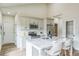 Kitchen boasts white cabinetry, stainless appliances, and marble counters adjacent to a seating area at the island at 623 Hamilton E Holmes Nw Dr, Atlanta, GA 30318