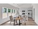 Bright dining area adjoining a kitchen with marble counters, a stainless steel fridge, and modern pendant lighting at 623 Hamilton E Holmes Nw Dr, Atlanta, GA 30318