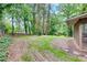 Spacious, tree-lined backyard with some grass area behind the house at 629 Hickory Se Trl, Mableton, GA 30126