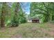 Lush backyard featuring mature trees and a view of the house at 629 Hickory Se Trl, Mableton, GA 30126