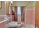 Pink tiled bathroom showcasing a sink, toilet, and bathtub with shower at 629 Hickory Se Trl, Mableton, GA 30126