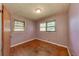 Bedroom showcasing wood floors and two windows at 629 Hickory Se Trl, Mableton, GA 30126