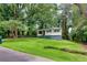 Home with a tree in the yard and a long driveway at 629 Hickory Se Trl, Mableton, GA 30126