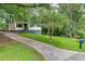 Home with a long driveway and a lush, green front lawn at 629 Hickory Se Trl, Mableton, GA 30126