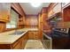 Retro kitchen featuring wood cabinets and older appliances in need of an update at 629 Hickory Se Trl, Mableton, GA 30126