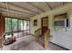 Enclosed back porch with lawn care equipment at 629 Hickory Se Trl, Mableton, GA 30126