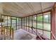 View of the covered screened porch with wood accents, overlooking the backyard at 629 Hickory Se Trl, Mableton, GA 30126