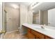 Bathroom featuring a single vanity, shower with glass door, and neutral tile floor at 1343 Penhurst Dr, Lawrenceville, GA 30043