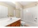 Clean bathroom featuring a tub/shower combo, vanity with sink, and linen storage at 1343 Penhurst Dr, Lawrenceville, GA 30043