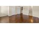 A bedroom with hardwood floors and neutral walls leads to a bathroom and double closets at 1343 Penhurst Dr, Lawrenceville, GA 30043