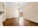 Dining area features hardwood floors, modern chandelier, and sliding door to patio at 1343 Penhurst Dr, Lawrenceville, GA 30043