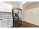 Well-equipped kitchen with stainless steel refrigerator, granite countertops, and ample cabinet space at 1343 Penhurst Dr, Lawrenceville, GA 30043