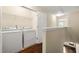 Convenient laundry area featuring a washer, dryer, and wire shelving for storage at 1343 Penhurst Dr, Lawrenceville, GA 30043